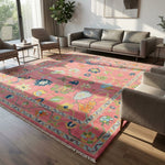 Wide-angle view of the Pink Hand Knotted Rug in a modern living room, showcasing its vibrant color and plush texture under natural sunlight.