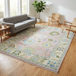 Full view of a light pink modern Oushak rug in a stylish living room, emphasizing plushness and detailed craftsmanship.