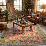 Artistic scene of pink Turkish Oushak rug in a bohemian loft, styled with eclectic decor, vintage furniture, and warm golden-hour lighting.