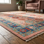 Macro shot of pink Turkish Oushak hand-knotted rug highlighting intricate pattern, micro texture, and artisan craftsmanship with cinematic lighting.