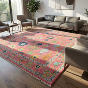 Wide-angle view of the Pink Hand Knotted Rug in a modern living room, showcasing its vibrant color and plush texture under natural sunlight.