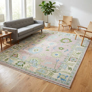 Full view of a light pink modern Oushak rug in a stylish living room, emphasizing plushness and detailed craftsmanship.