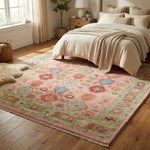 Large pink Turkish Oushak hand-knotted rug in a warm, inviting bedroom setting, showcasing micro-texture and detailed knotwork with soft natural lighting.
