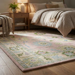 Side perspective of a pink Oushak rug in a bedroom corner focusing on edge finish and dense knot work.